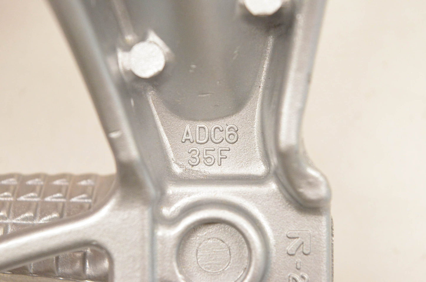 New OEM Suzuki ADC6 35F Rear Footrest Bracket NOS