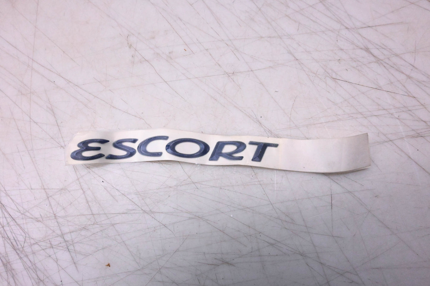 New OEM Ford F7CZ-5442528-CE Escort Nameplate NOS