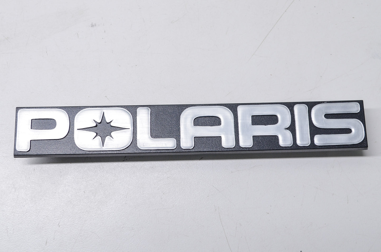 New OEM Polaris 5430724 Black/Silver Bumper Emblem NOS