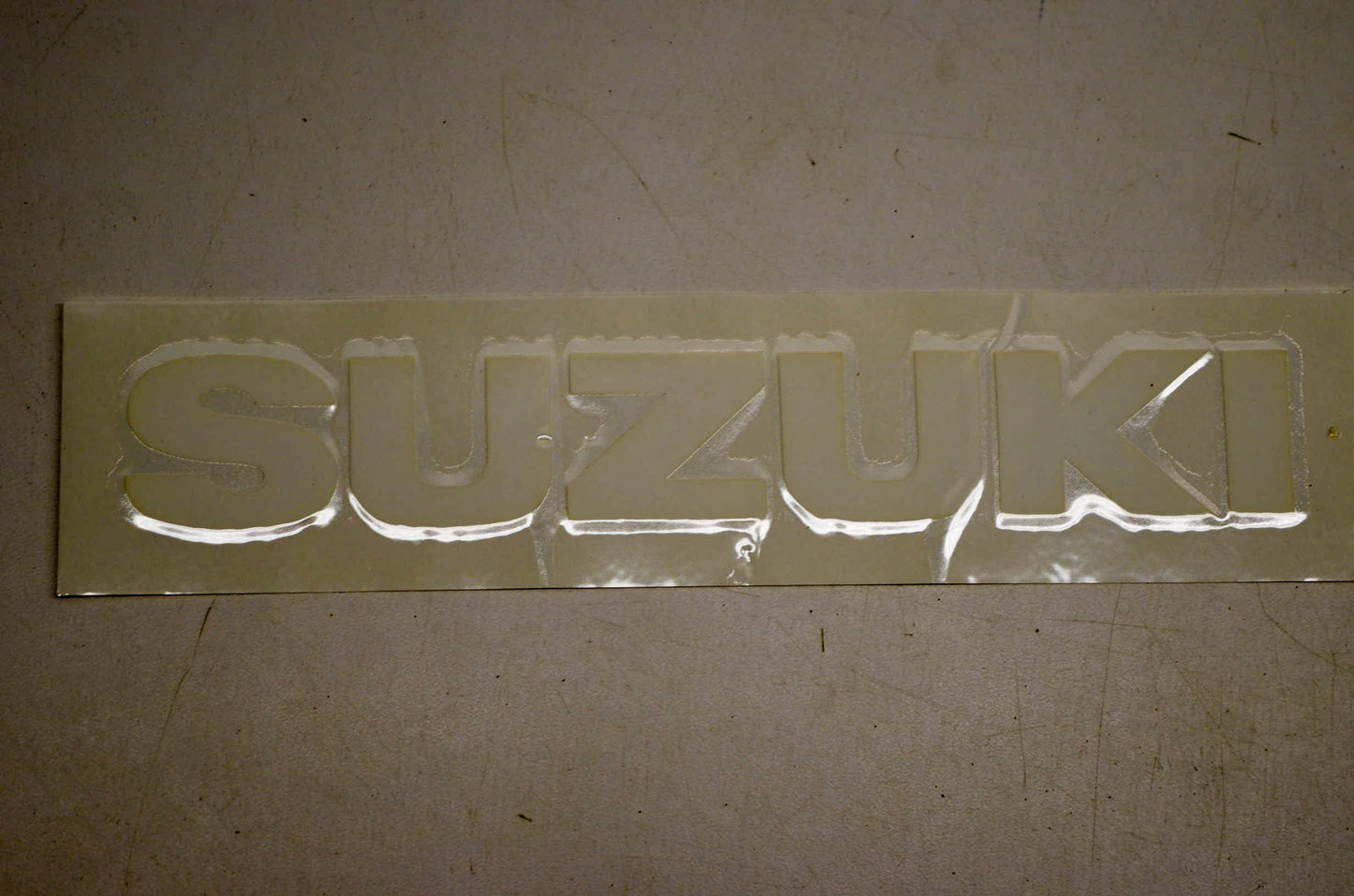 New OEM Suzuki 68111-40B01-064 Emblem White NOS