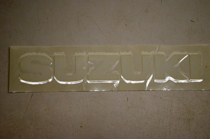 New OEM Suzuki 68111-40B01-064 Emblem White NOS