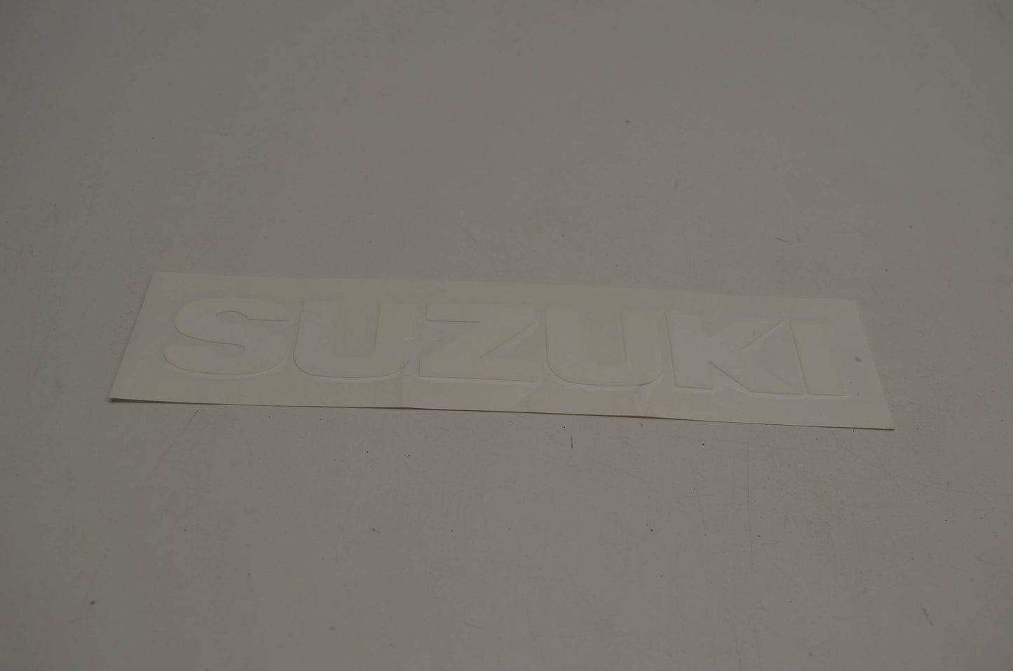 New OEM Suzuki 68111-40B01-064 Emblem White NOS