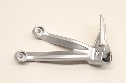New OEM Suzuki ADC6 35F Rear Footrest Bracket NOS