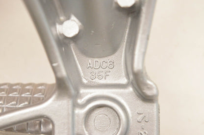 New OEM Suzuki ADC6 35F Rear Footrest Bracket NOS